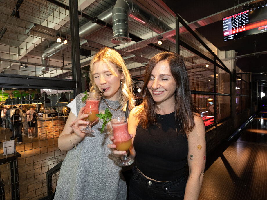 Fiasco Design turns 13! Photo shows 2 females drinking cocktails.