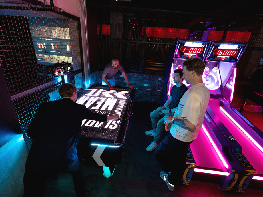 Fiasco Design turns 13! Photo shows people playing air hockey.