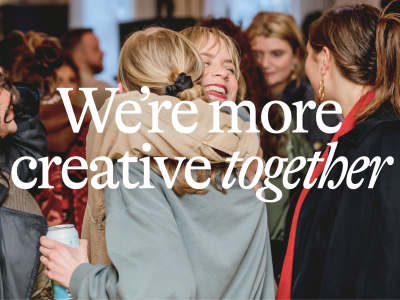 Gather Round tagline 'we're more creative together' overlaid on photo of a crowd of people with two in the foreground hugging.