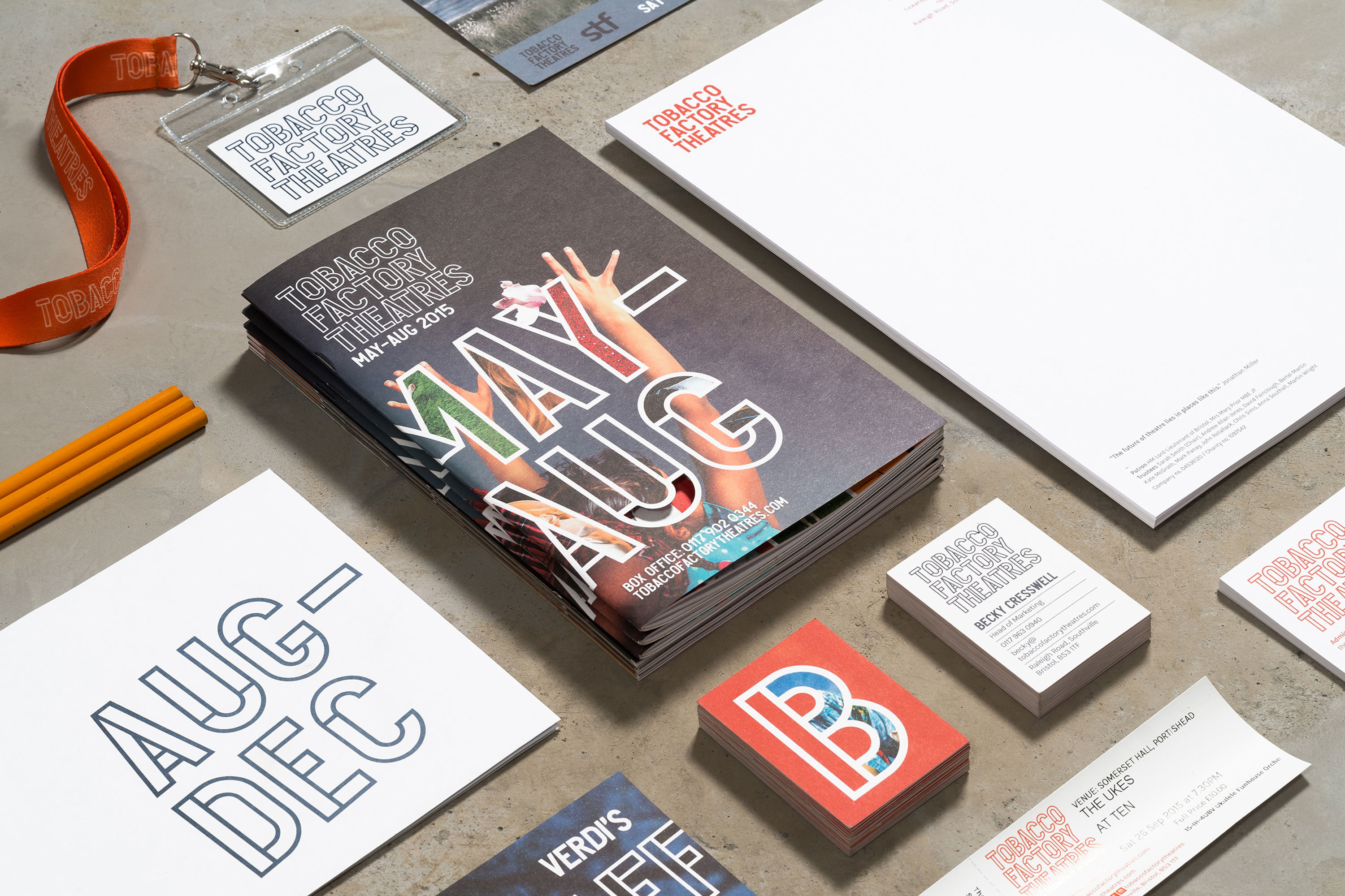 Tobacco Factory Theatres brand in action. Image shows a variety of brand assets laid out, including lanyards, brochures, posters and business cards. Image is engaging and dynamic.