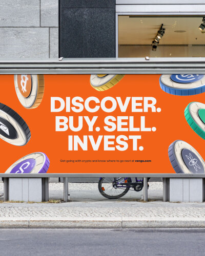 Venga billboard mock up. The billboard shows various crypto coins. Each coin type has a central circular colour - including orange, aqua, blue, purple and black - which is also repeated along its edge. The centre circle contains the coin's icon and shortened name in white. Each coin type has its own subtle textured brand pattern. The coins float in front of an orange background. The headline reads 'Discover. Buy. Sell. Invest' in white bold all caps. There is a small call to action line with a weblink to venga.com. The billboard is placed within a street scene, there is a concrete wall and shopfront behind it. Two bikes in partial view lean against it.