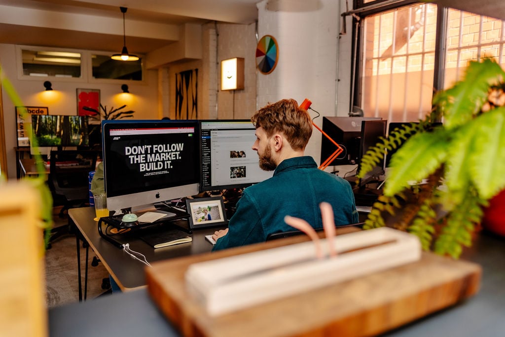 Developer Tom working at his screen on the Charlie Oscar project